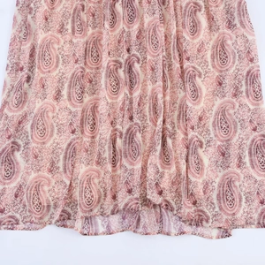 Close-up detail of paisley printed fabric in pink and purple for women's dress