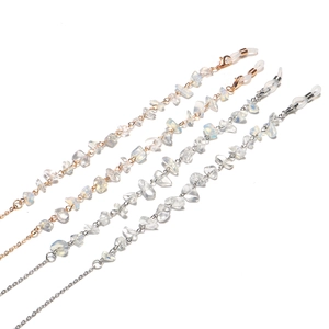 Detail of crystal beads and gold silver chains for glasses and face mask holders