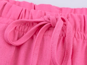 Vue détaillée de la taille élastique et du cordon sur le pantalon rose en lin mélangé