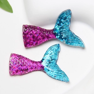 Macro view of gradient purple and blue resin mermaid tails with glitter scale texture