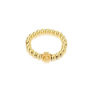 Golden stretch bead ring featuring a polished four-leaf clover charm on a white background