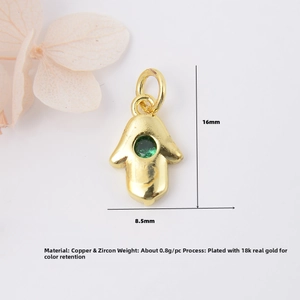Detailed view of 16mm x 8.5mm Hamsa pendant with green zircon and 18K gold plating
