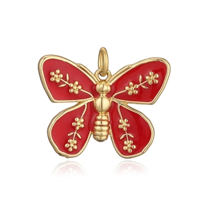 Macro detail of red enamel butterfly pendant with elegant golden plating on white background