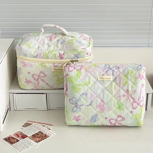 Quilted mint green cosmetic bag set with floral patterns and a portable handle design