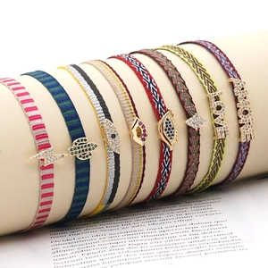 Handmade woven friendship bracelets set with rhinestone charms and colorful patterns