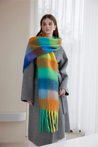 Close-up of colorful plaid scarf with brushed texture and tassel edge detail