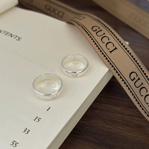 Minimalist 925 sterling silver open ring featuring a hollow heart design on a desk