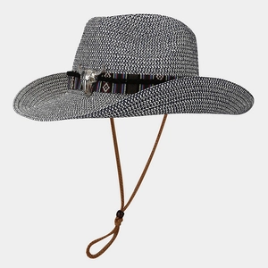 Detail of woven straw cowboy hat with ethnic band and silver buffalo skull ornament
