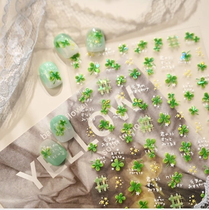 Detail showing green four-leaf clover nail stickers with gold stars and text on vintage paper