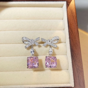 Elegant S925 silver bow stud earrings with pink ice flower cut zircon in a jewelry box