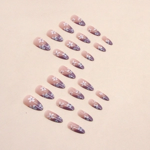 Almond-shaped purple French press-on nails with white daisy floral design and gradient