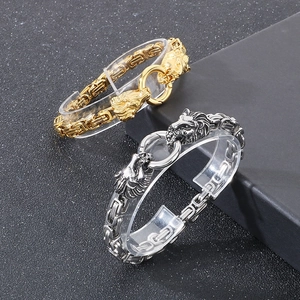 Men's hip hop lion head link bracelets in gold and silver finish on display stands