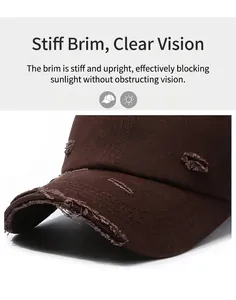 Detailed close-up view of the distressed ripped edges and fabric texture on a brown baseball cap