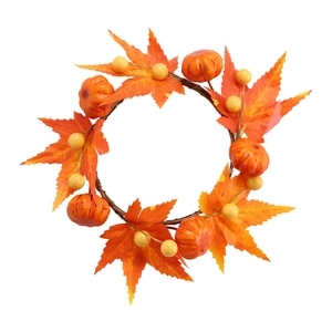 Autumn wreath with orange maple leaves, mini pumpkins and berries for Halloween decor