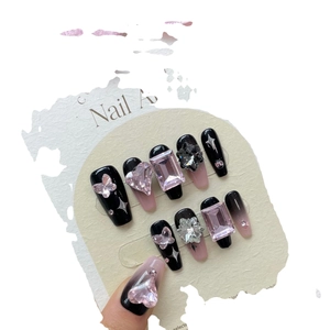 Handmade black and pink Y2K press-on nails with heart gems and charms