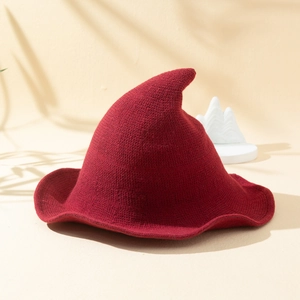 Close-up of wine red knitted witch hat showing high-quality wool texture and pointed top