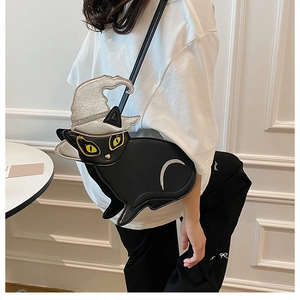 Detail of black cat shaped crossbody bag with silver glitter wizard hat and fine stitching