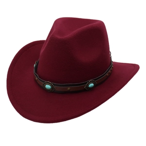 Detail of wine red western cowboy hat with turquoise studs and brown leather band