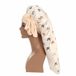 Detailed side view of long satin butterfly print bonnet with silk bow ties and ribbon