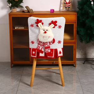 Detail of Christmas chair cover with 3D reindeer design on wooden dining chair