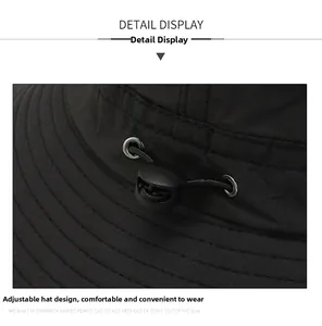 Detail view of the adjustable drawstring with plastic toggle on a black outdoor sun hat