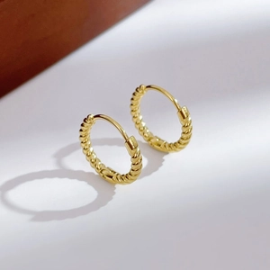 Elegant gold twisted hoop earrings with woven texture and secure clasp for women
