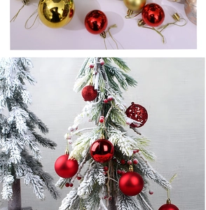 Detail of red and gold Christmas balls with matte and glitter textures on a flocked tree