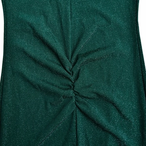 Detailed view of green glitter fabric dress featuring textured ruching and sparkle finish