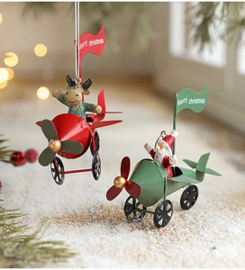 Detail of Christmas iron mini planes with Santa and reindeer hanging in warm festive light