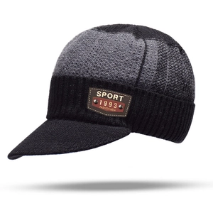 Detail of the knit texture and brown leather label on the men's winter beanie hat