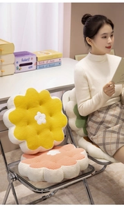 Close-up of a floral waffle fabric cushion on a chair in a cozy lifestyle setting