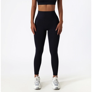 Detail of high-waist yoga pants with side pockets and slimming elastic compression fit