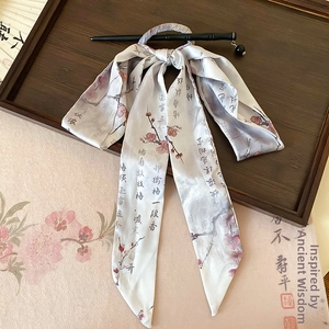 Detail of bamboo-style hair pin with silk ribbon featuring plum blossom and calligraphy