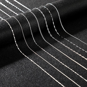Close-up of various silver chain styles including bead, water wave, and snake chain designs