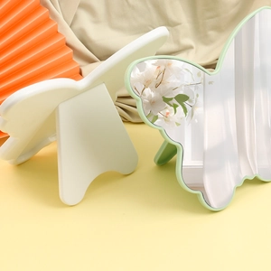 Butterfly shaped portable makeup mirrors in white and green with foldable stands