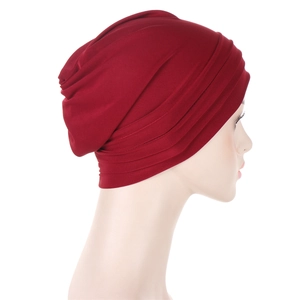 Side view of dark red pleated headscarf for women featuring elastic fabric texture