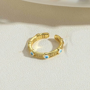 Detailed close-up of 14K gold plated evil eye ring with blue white enamel and crystals