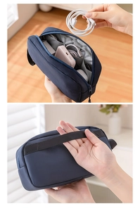 Detail of dark blue digital storage bag with internal compartments and side carry handle