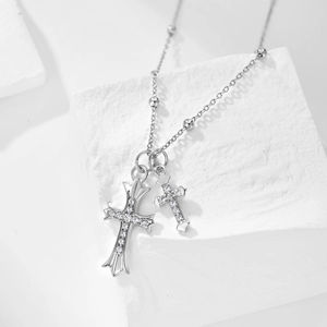 Close-up of S925 silver double cross necklace with opal shell pearl on white stone