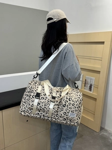 Large capacity leopard print travel duffel bag with shoulder strap for sports and gym use