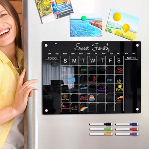 Smiling woman uses magnetic acrylic monthly calendar on fridge with 8 color markers