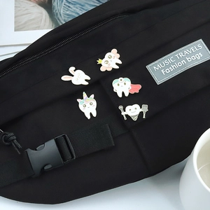 Cartoon tooth badges on a black nylon fanny pack featuring rabbit and dentist themes