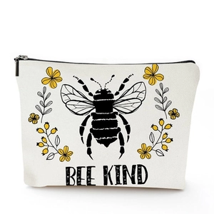 Close-up of linen makeup bag with Bee Kind bee and flower print and black zipper