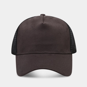 Detailed close-up of brown suede trucker hat with black mesh and reinforced stitching