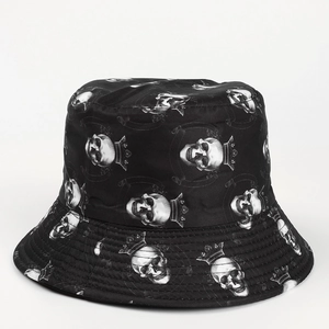 Detail of black bucket hat featuring skull and crown print with high-quality fabric texture