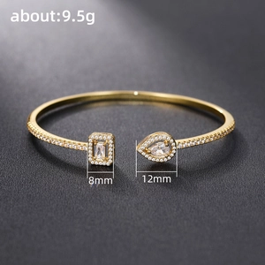 Detailed view of adjustable gold bangle with zirconia accents and measurement labels