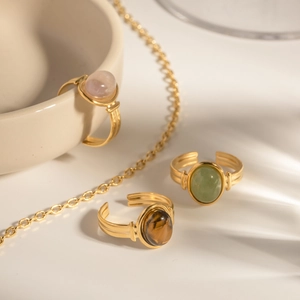 Gold-plated stainless steel oval gemstone rings set with pink, green, and tiger eye stones