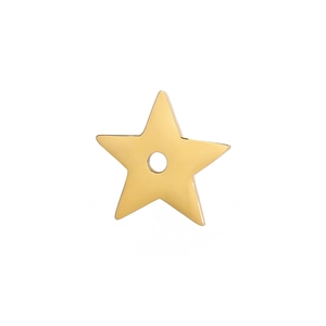 Macro shot of gold star-shaped stainless steel pendant with central hole for DIY jewelry