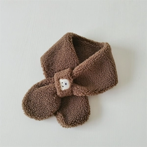 Detailed view of brown plush cross scarf with cute bear embroidery on soft fleece