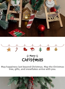 Close-up of wooden Santa ladder, glowing cabin, and candy cane Christmas ornaments